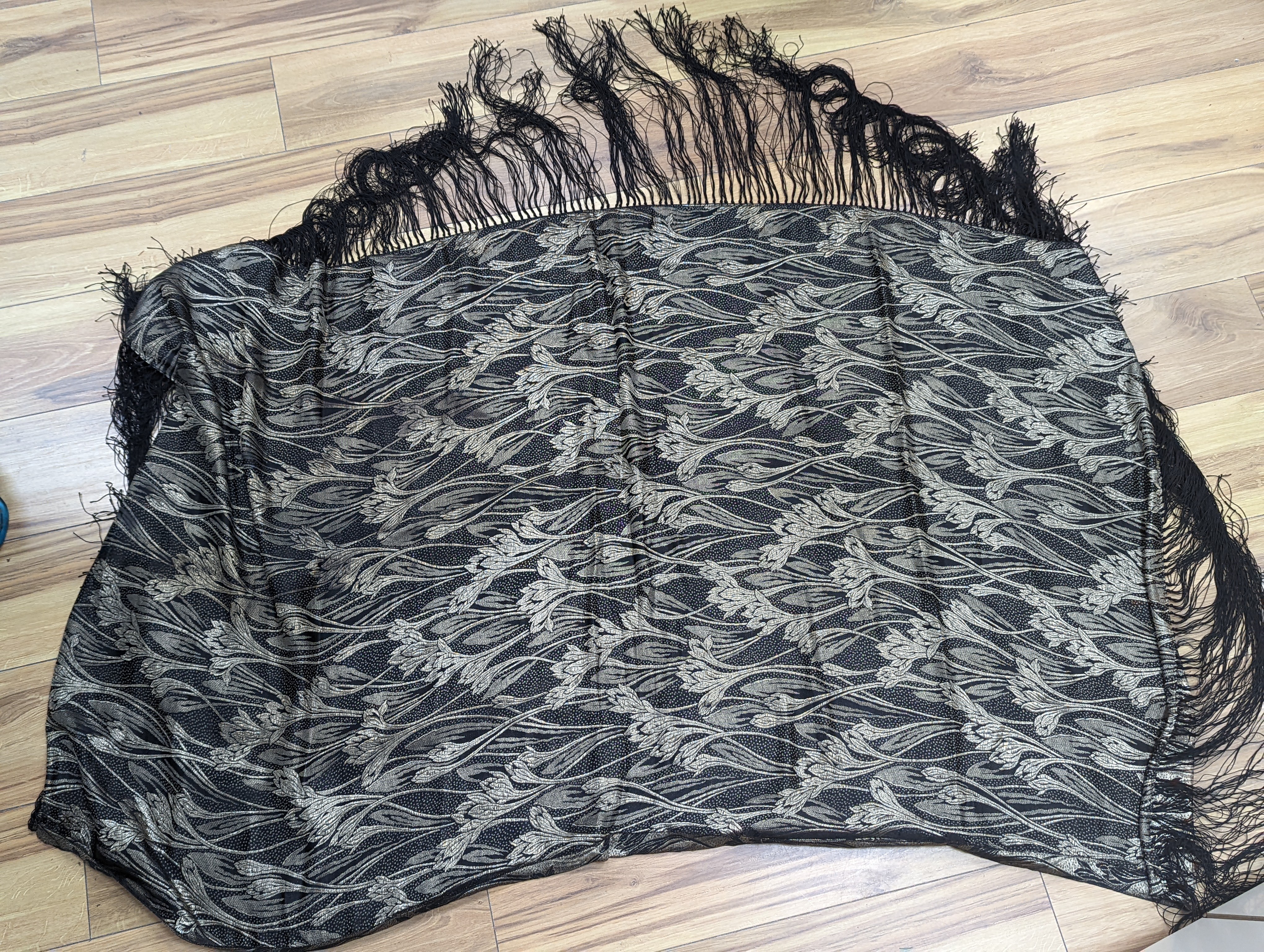 A 19th century silk woven shawl, a 1930's cut velvet shawl, a printed crepe de chine shawl, a black and gold lurex shawl and a multicoloured lurex stole (5)